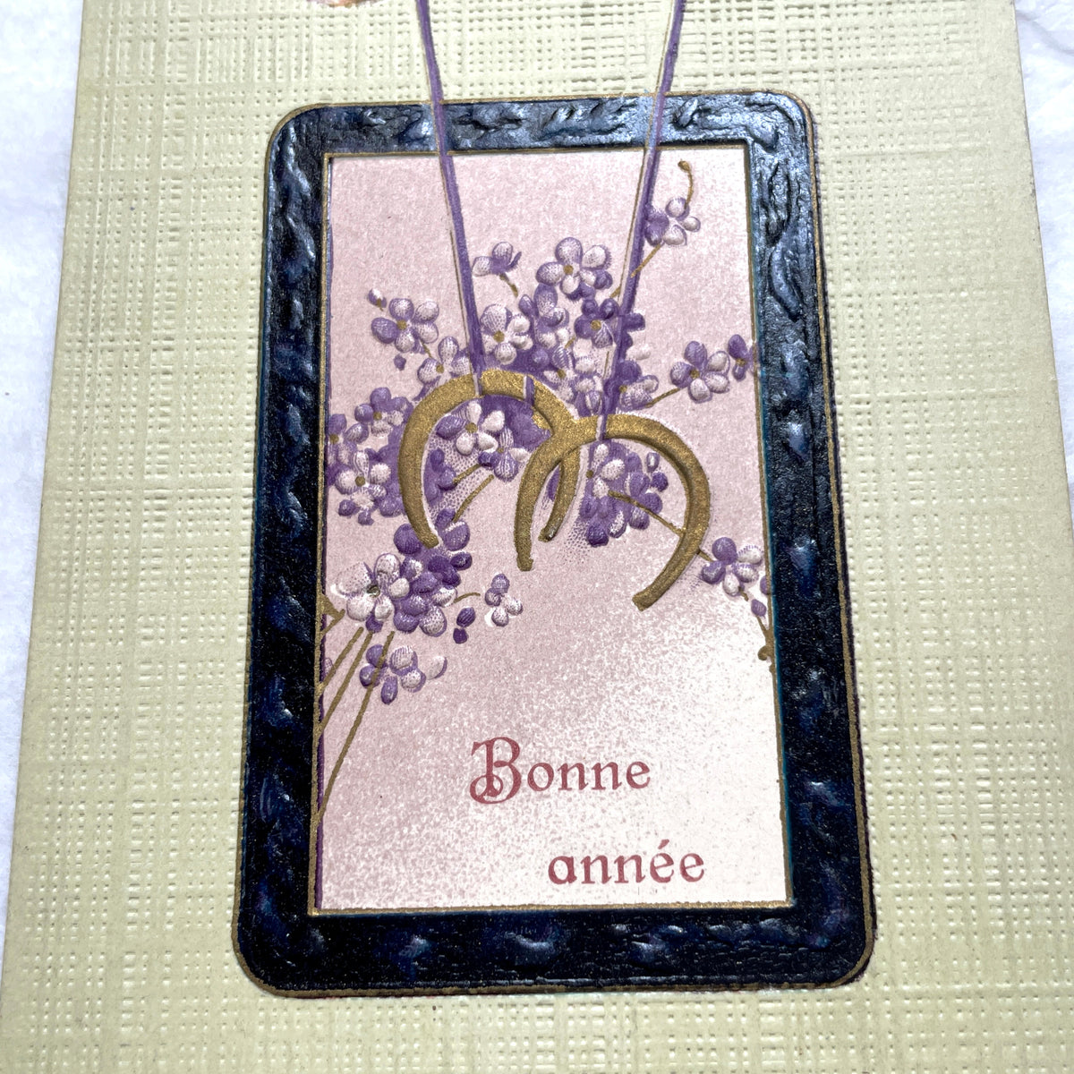 1900s New Year postcard with swallows carrying a good luck horseshoe and 'Bonne année' French text.
