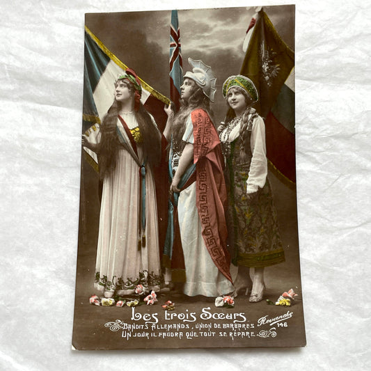 1910s French WWI postcard featuring three allegorical women representing France, Britain, and Russia with flags.