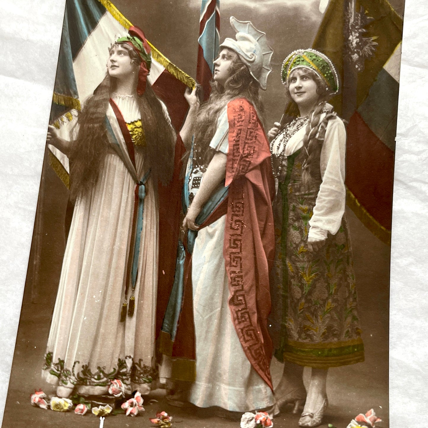 1910s French WWI postcard featuring three allegorical women representing France, Britain, and Russia with flags.