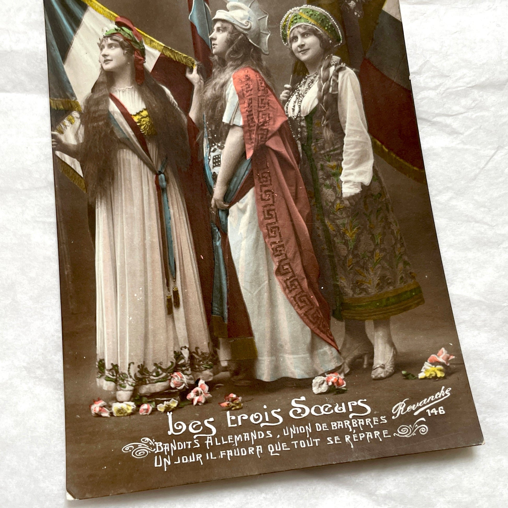 1910s French WWI postcard featuring three allegorical women representing France, Britain, and Russia with flags.