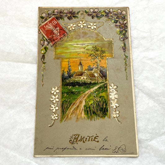 1900s French postcard featuring a gilded church landscape, floral border, and an antique 10c Postes stamp.