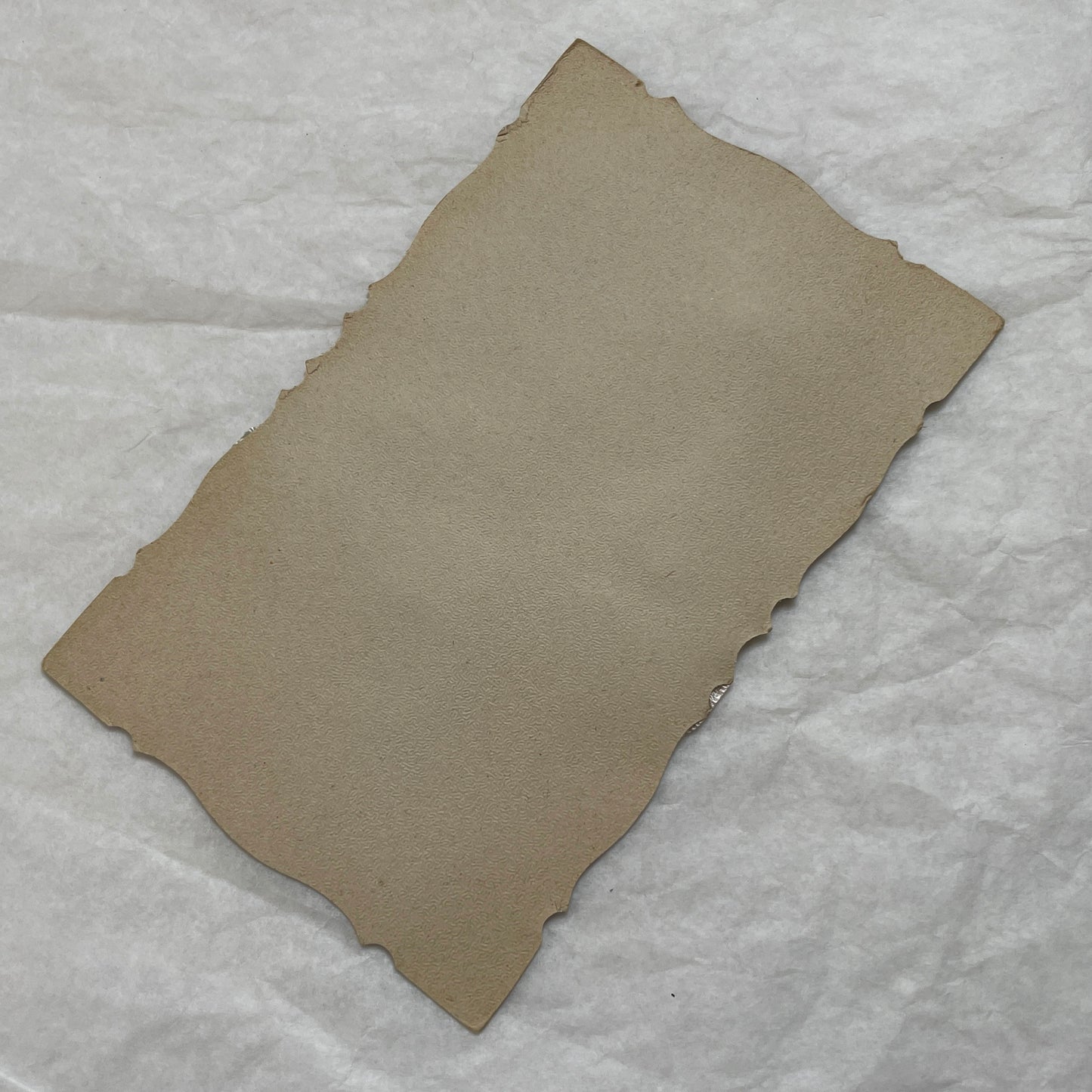 1930s vintage decorative card with a sepia wedding couple photo, golden embossed basket, and pastel ribbons on silver.