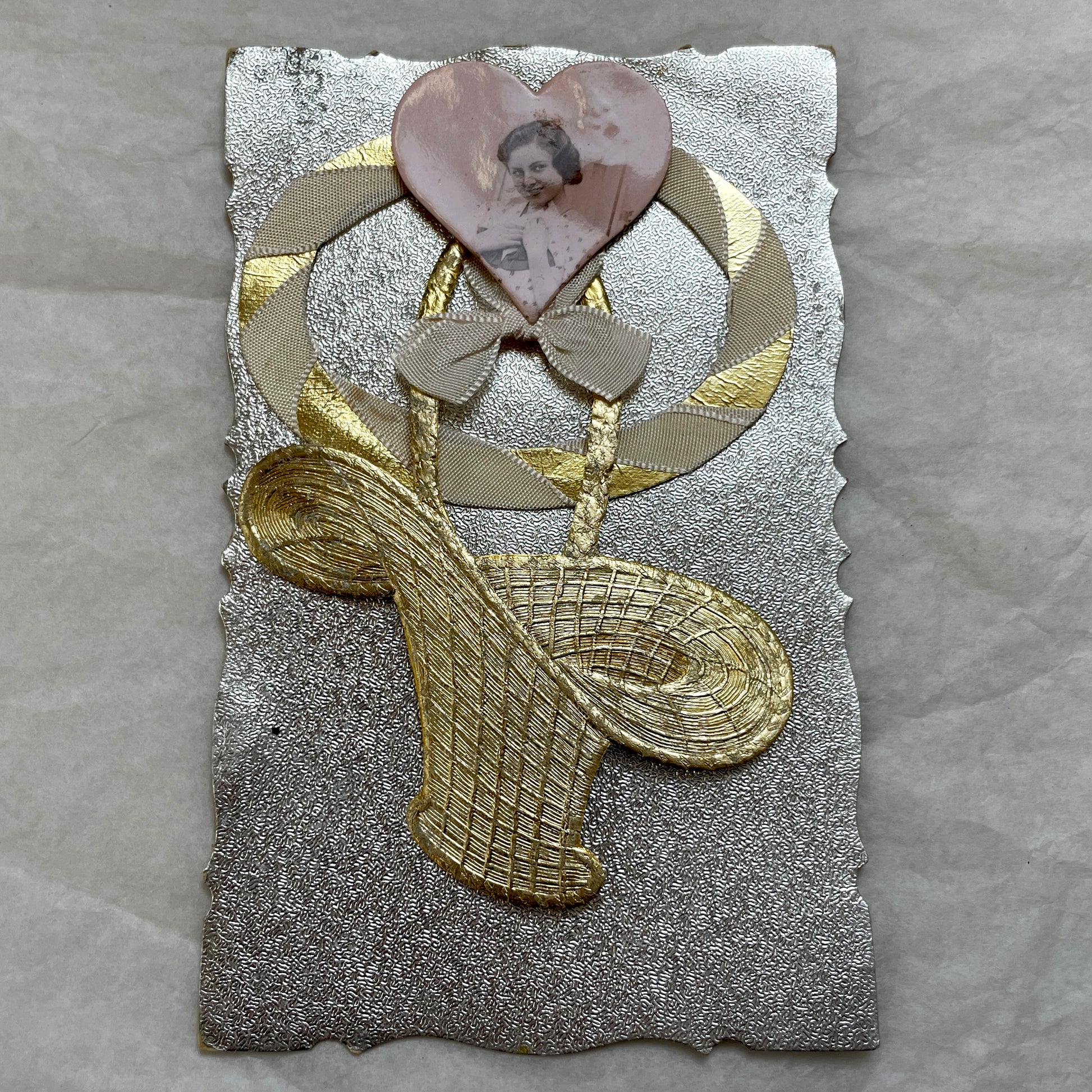 1930s Vintage Keepsake Card with heart-shaped photo, gold weave, and silver embossed background. Elegant decorative piece.