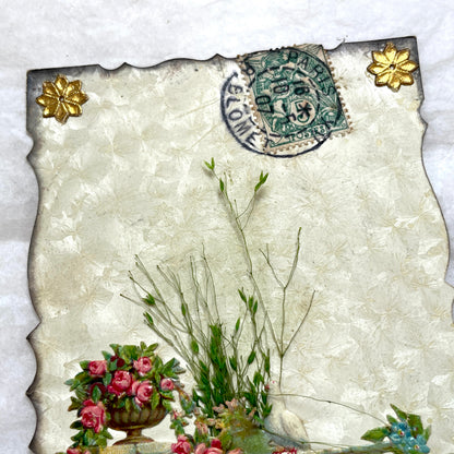1900s Antique French greeting card with embossed doves, pink roses, blue forget-me-nots, and original postal stamp.