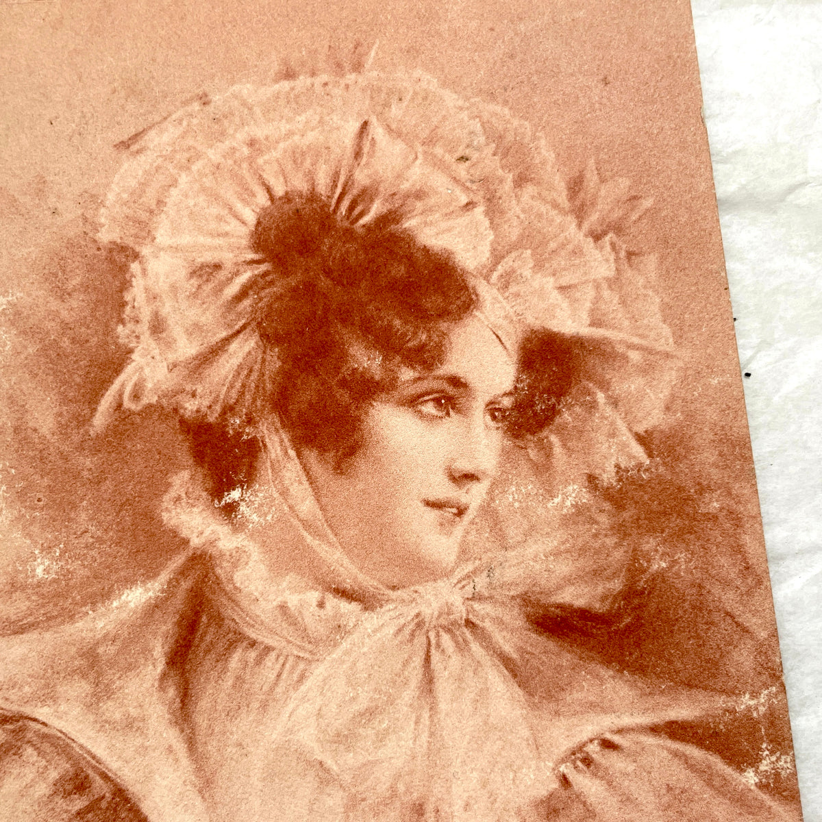 1900s French postcard with an elegant woman wearing a large, fashionable hat, stamped with a Toulouse postmark.