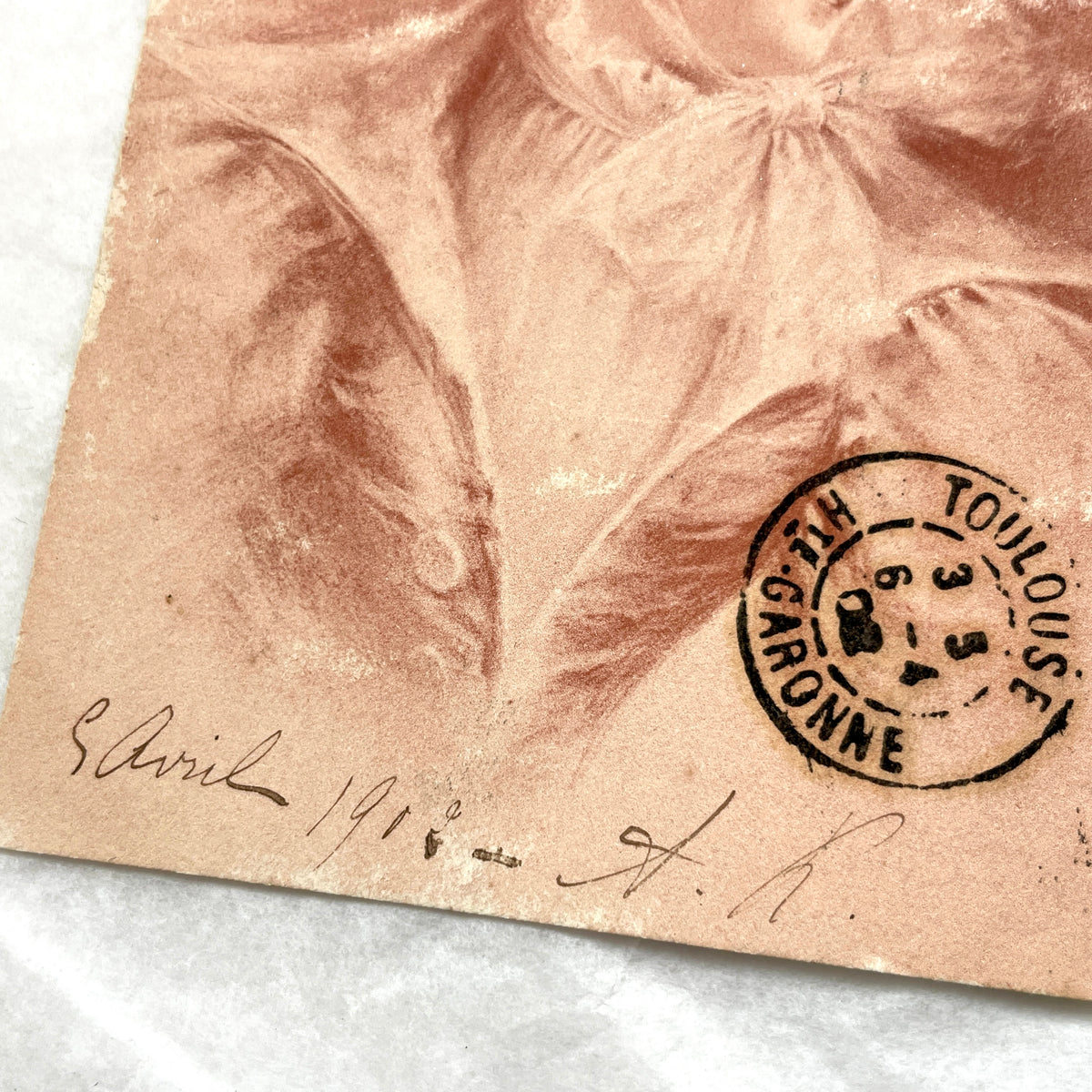 1900s French postcard with an elegant woman wearing a large, fashionable hat, stamped with a Toulouse postmark.