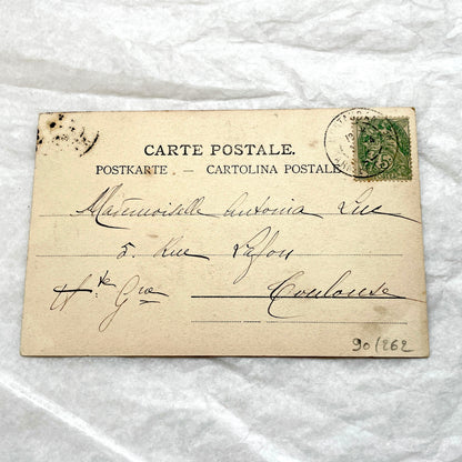 1900s French postcard with an elegant woman wearing a large, fashionable hat, stamped with a Toulouse postmark.