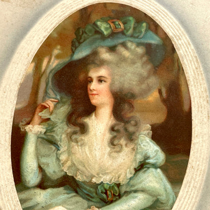 1910s French postcard depicting an elegant woman in an 18th-century teal dress and large hat, holding a book.