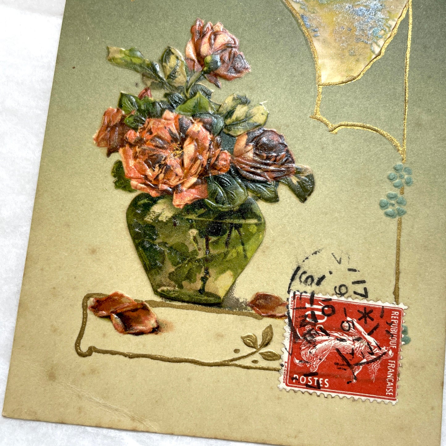 1910s French postcard with embossed roses in a vase, gilded decorative elements, a landscape vignette, and a red French stamp