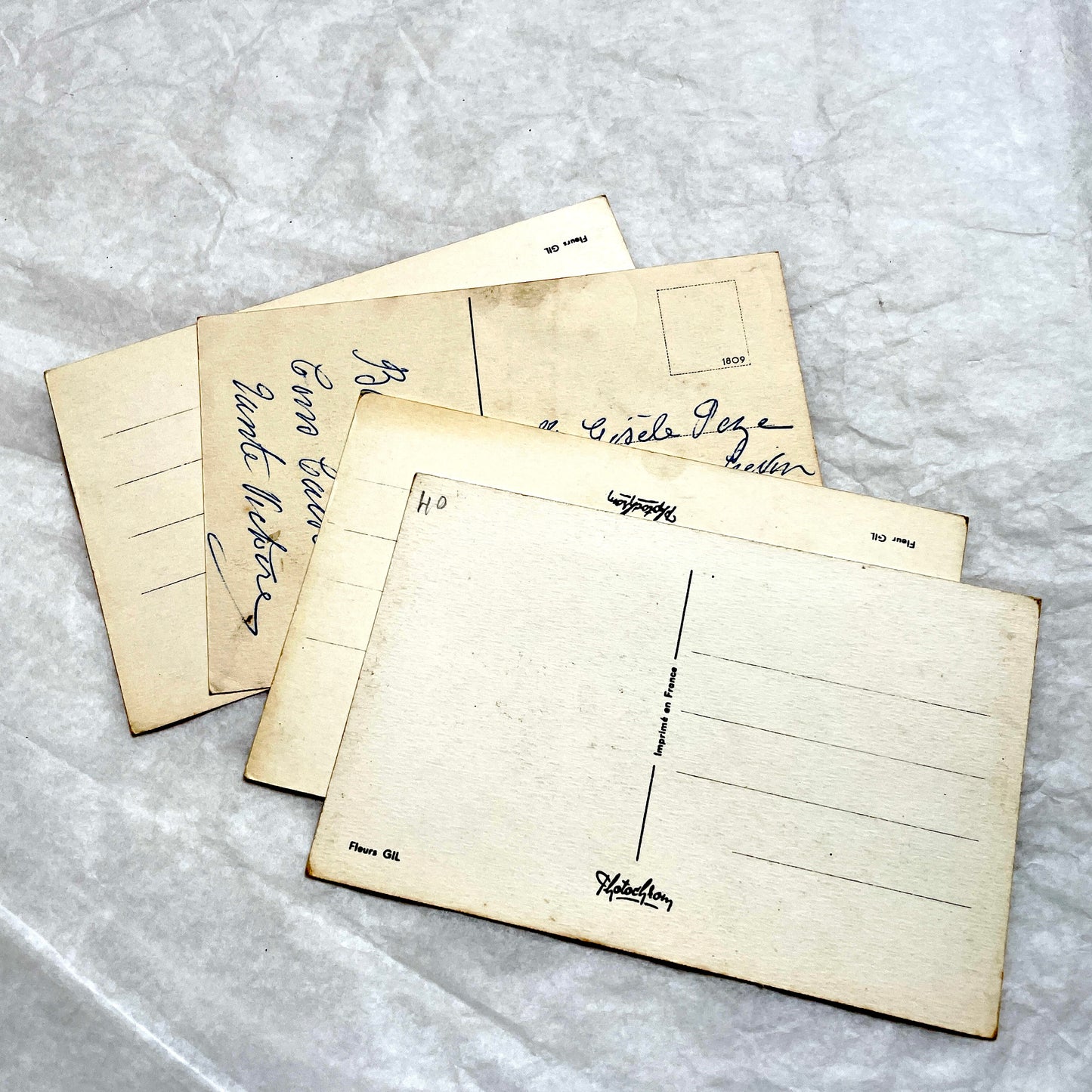 1930s vintage postcard lot featuring four unique illustrations of vibrant red and pink roses with green leaves, floral art.