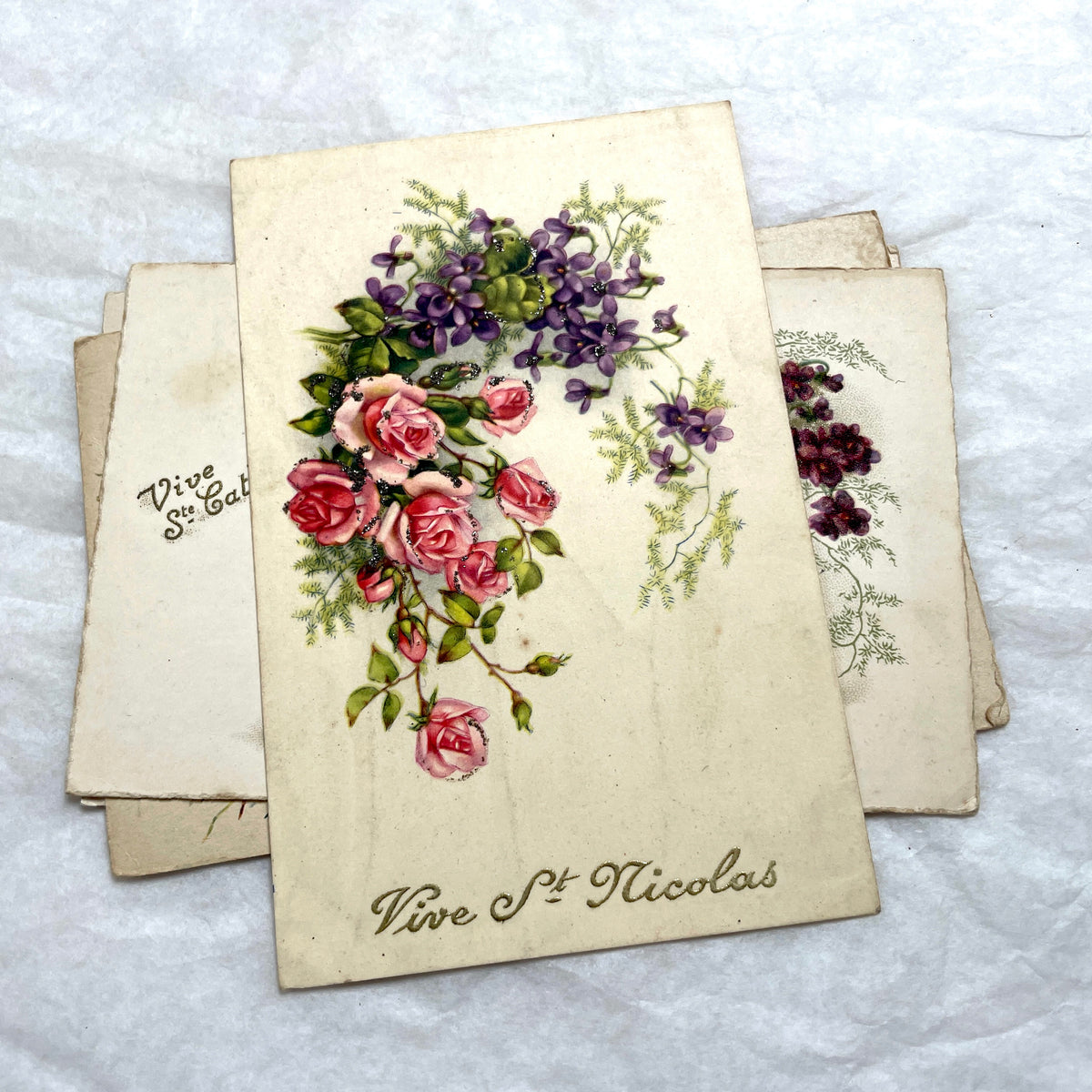 1900s French postcards lot with glitter floral designs and French text, vintage paper ephemera.