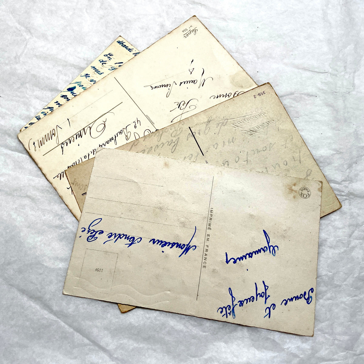 1900s French postcards lot with glitter floral designs and French text, vintage paper ephemera.
