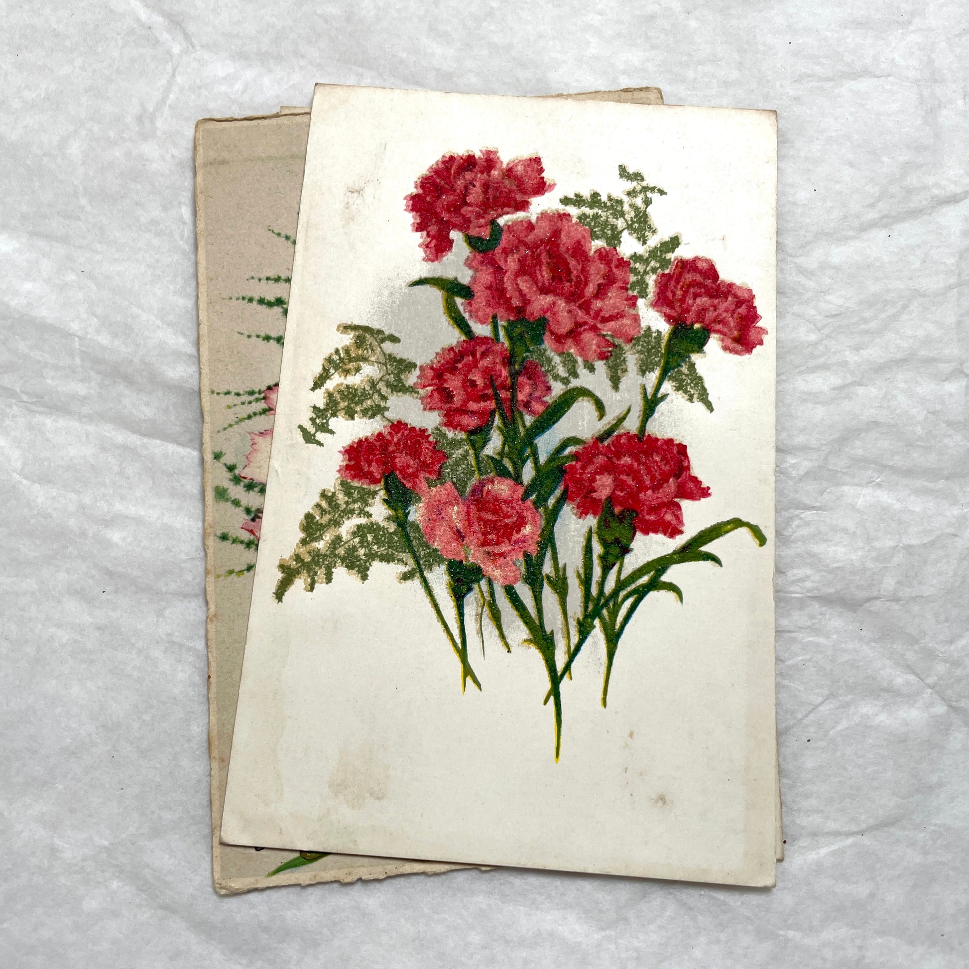 Lot of four 1950s carnation postcards featuring vibrant red and pink floral arrangements with French text.