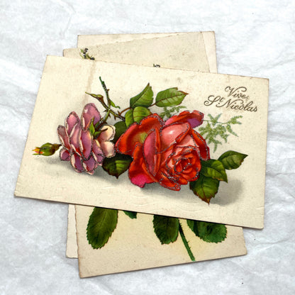 1910s French glitter postcard lot with purple pansies, pink roses, and red rose bouquets.