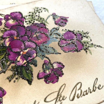 1910s French glitter postcard lot with purple pansies, pink roses, and red rose bouquets.