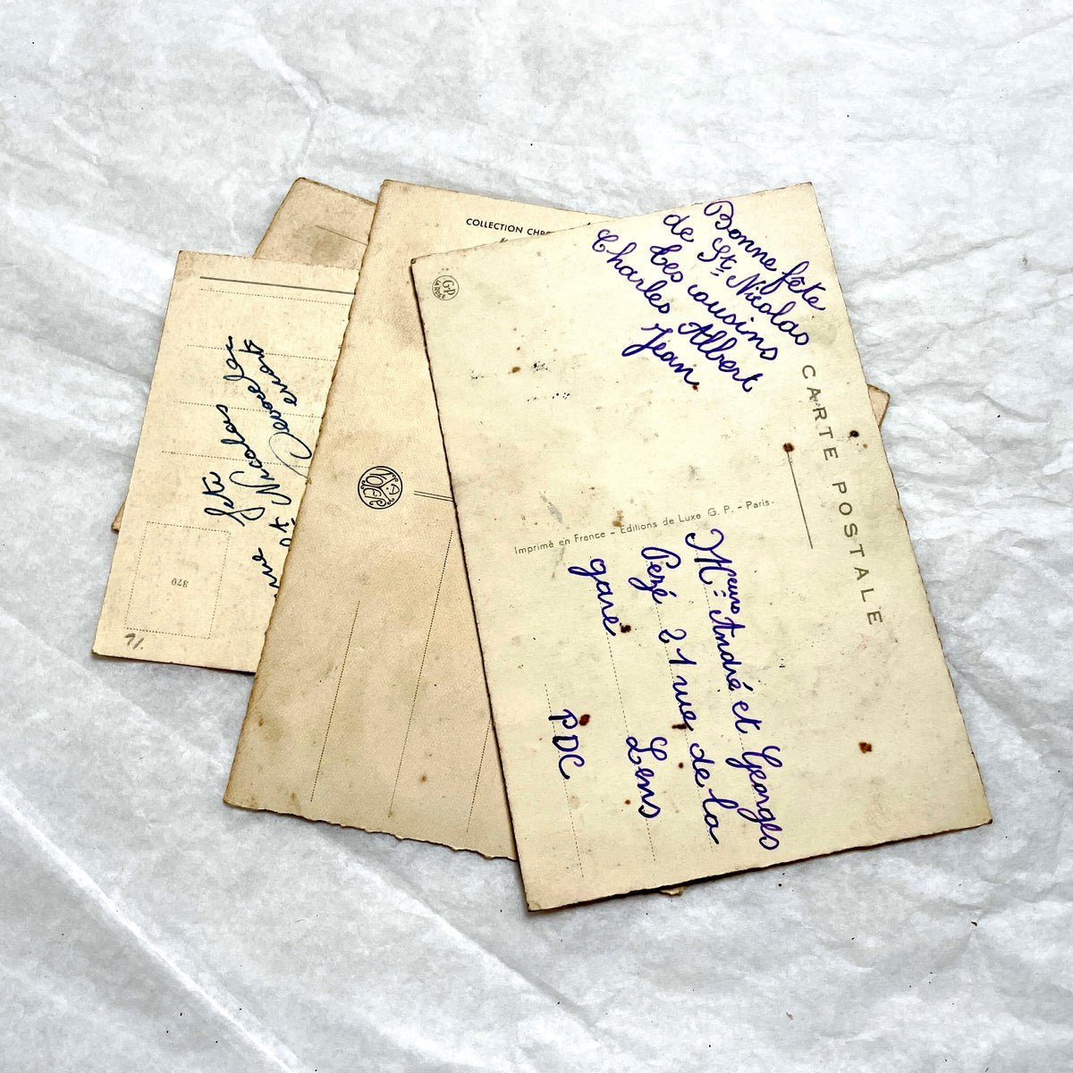 1910s French glitter postcard lot with purple pansies, pink roses, and red rose bouquets.