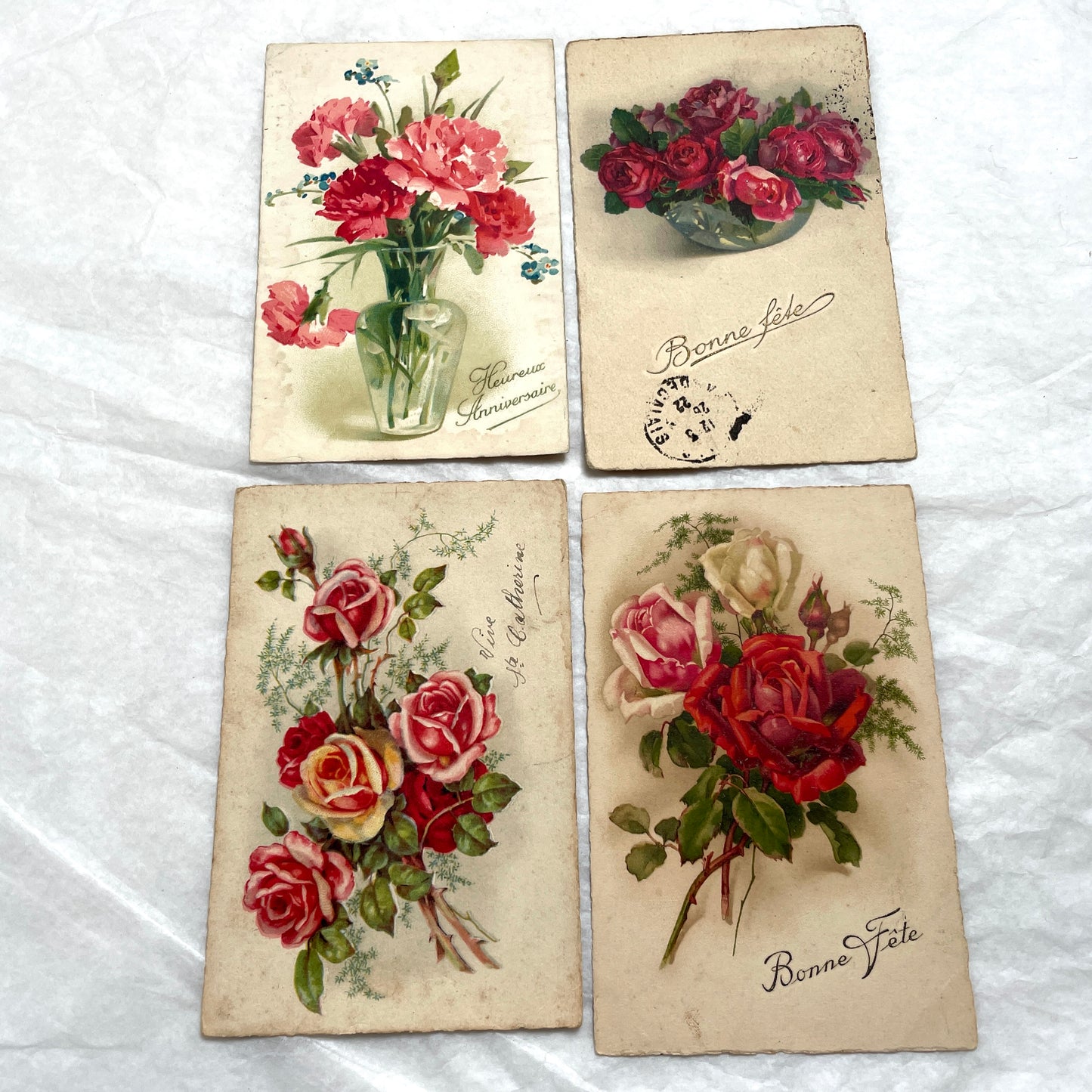 1900s French floral postcard lot featuring vintage illustrations of red roses and pink carnations in a classic style.