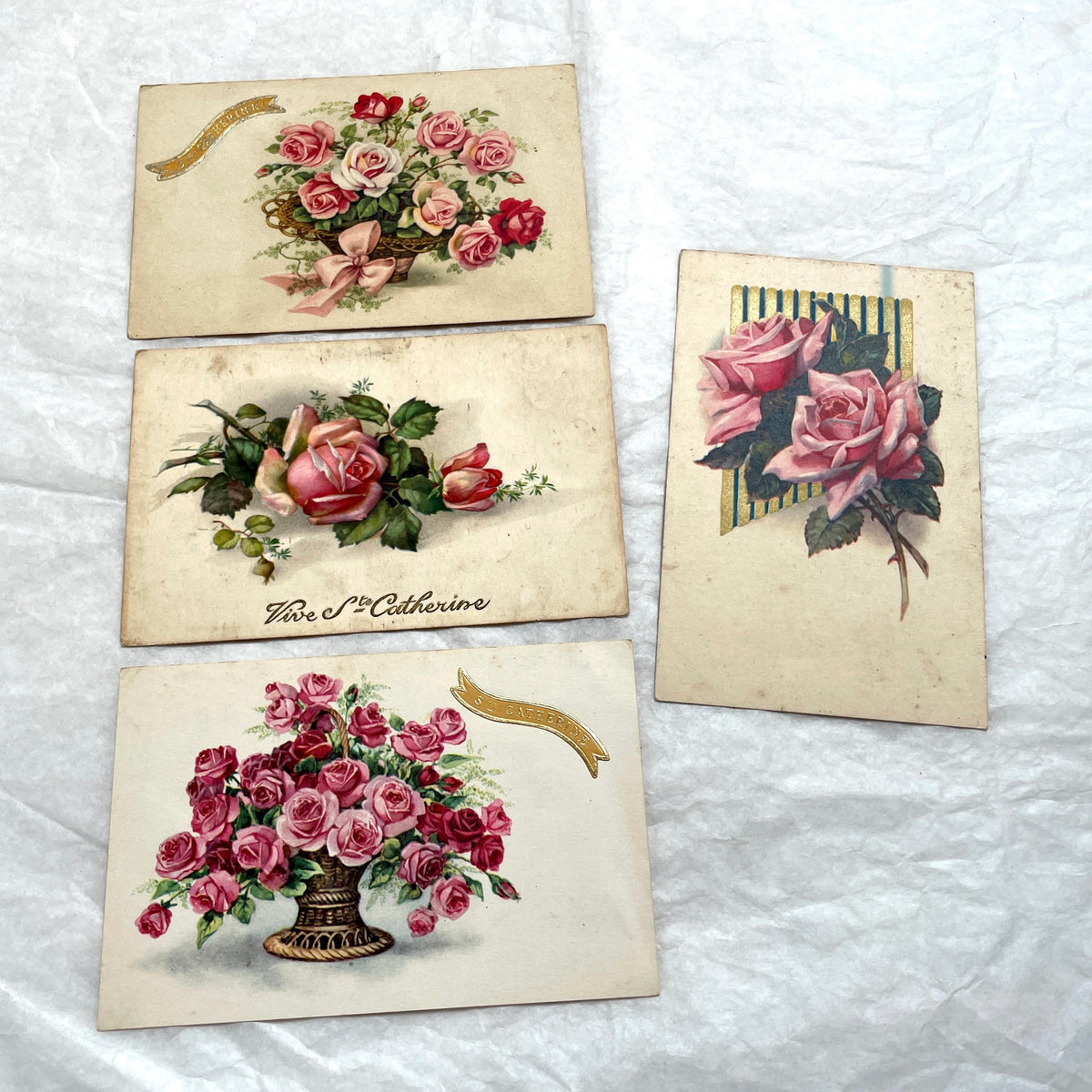 Four 1900s French vintage postcards with beautiful pink and red rose floral designs and 'St Catherine' banners.