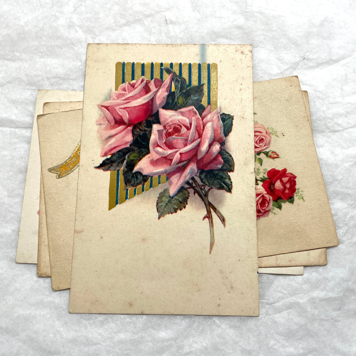 Four 1900s French vintage postcards with beautiful pink and red rose floral designs and 'St Catherine' banners.