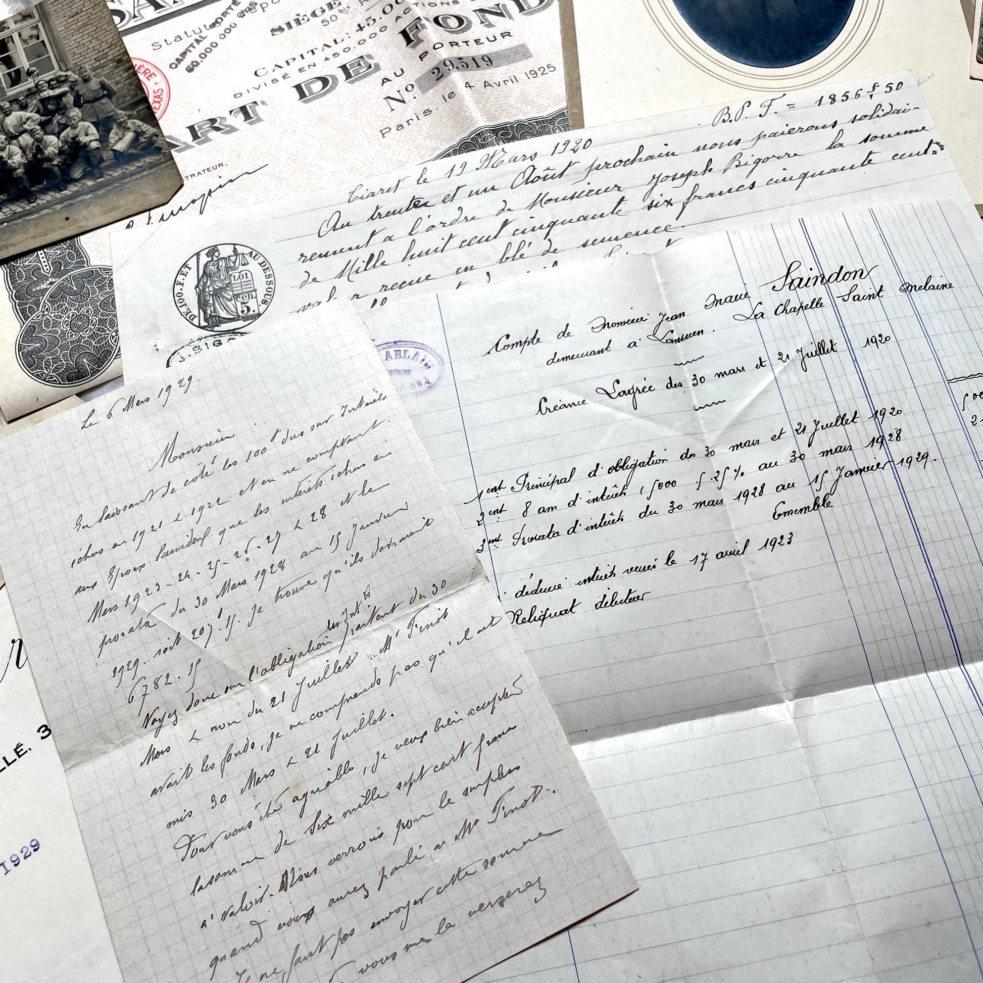1920s French Documents Lot with a share certificate, handwritten letters, sheet music, and an old photograph.