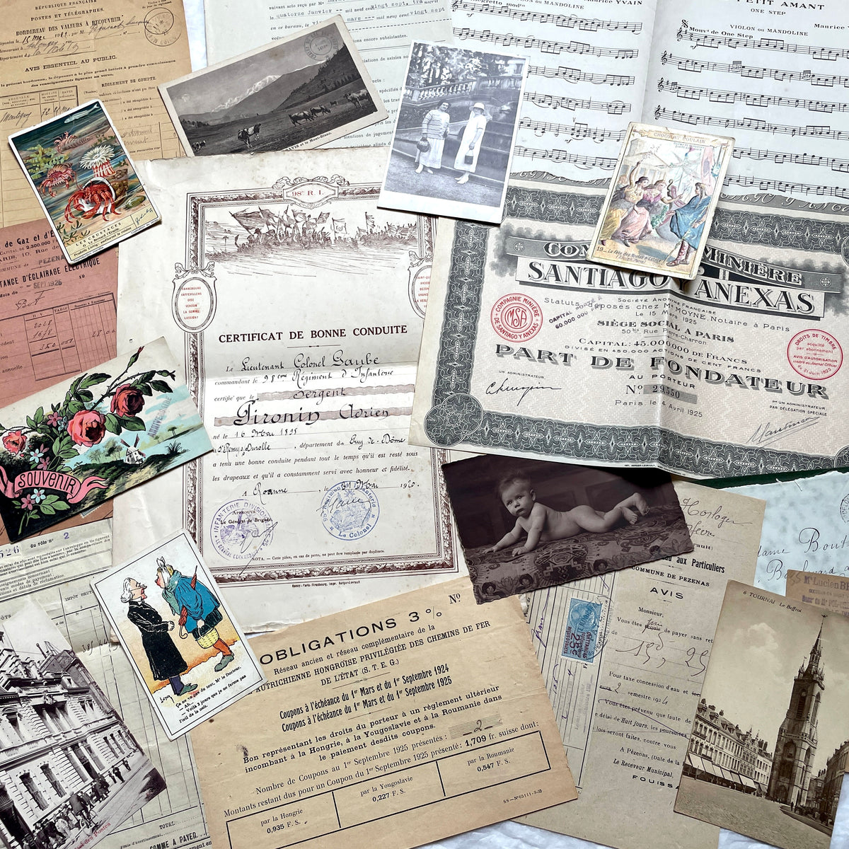 1920s French Ephemera Lot with various documents, vintage postcards, sheet music, period photos, and a stock certificate.