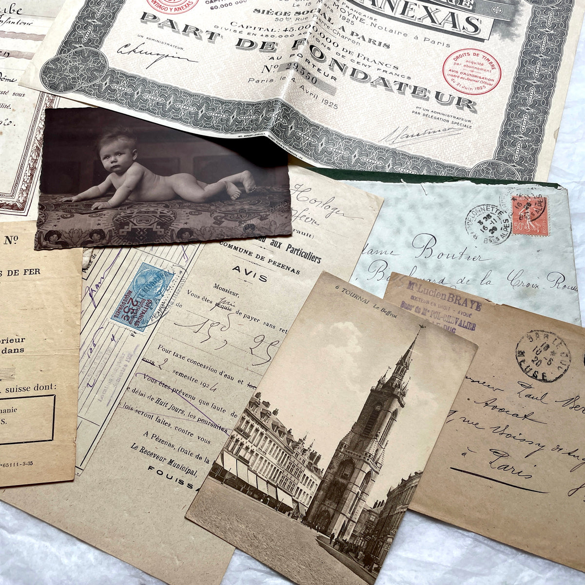 1920s French Ephemera Lot with various documents, vintage postcards, sheet music, period photos, and a stock certificate.