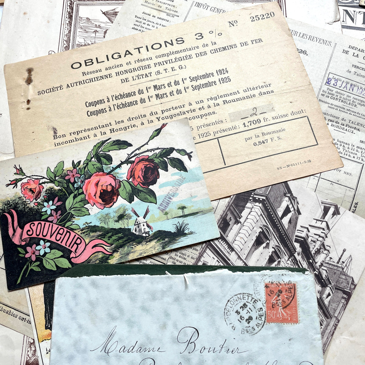 1920s French Ephemera Lot with various documents, vintage postcards, sheet music, period photos, and a stock certificate.