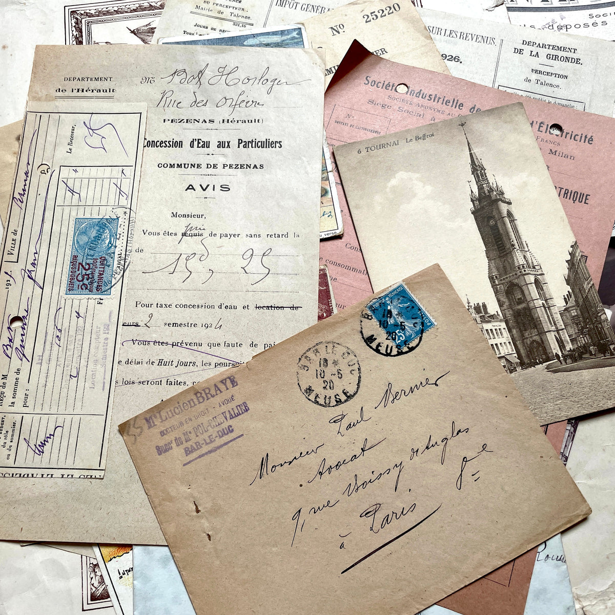1920s French Ephemera Lot with various documents, vintage postcards, sheet music, period photos, and a stock certificate.
