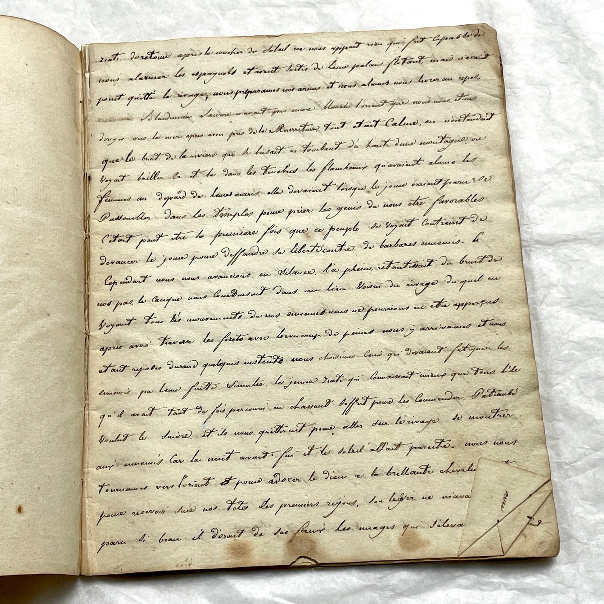Late 19th Century handwritten French manuscript book with aged pages open to reveal flowing script.