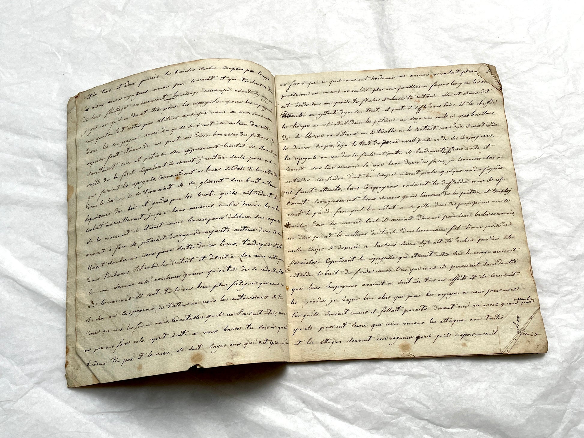 Late 19th Century handwritten French manuscript book with aged pages open to reveal flowing script.