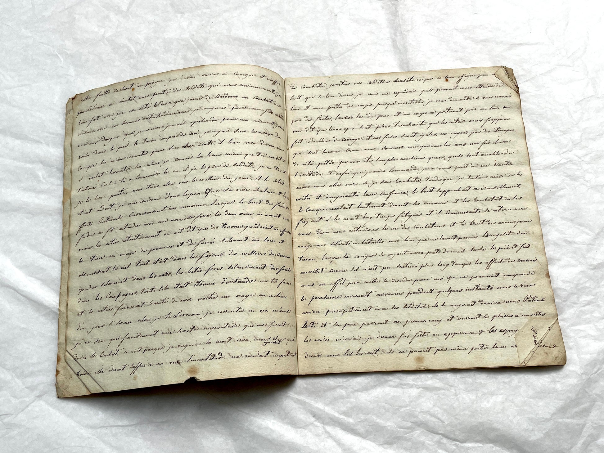 Late 19th Century handwritten French manuscript book with aged pages open to reveal flowing script.