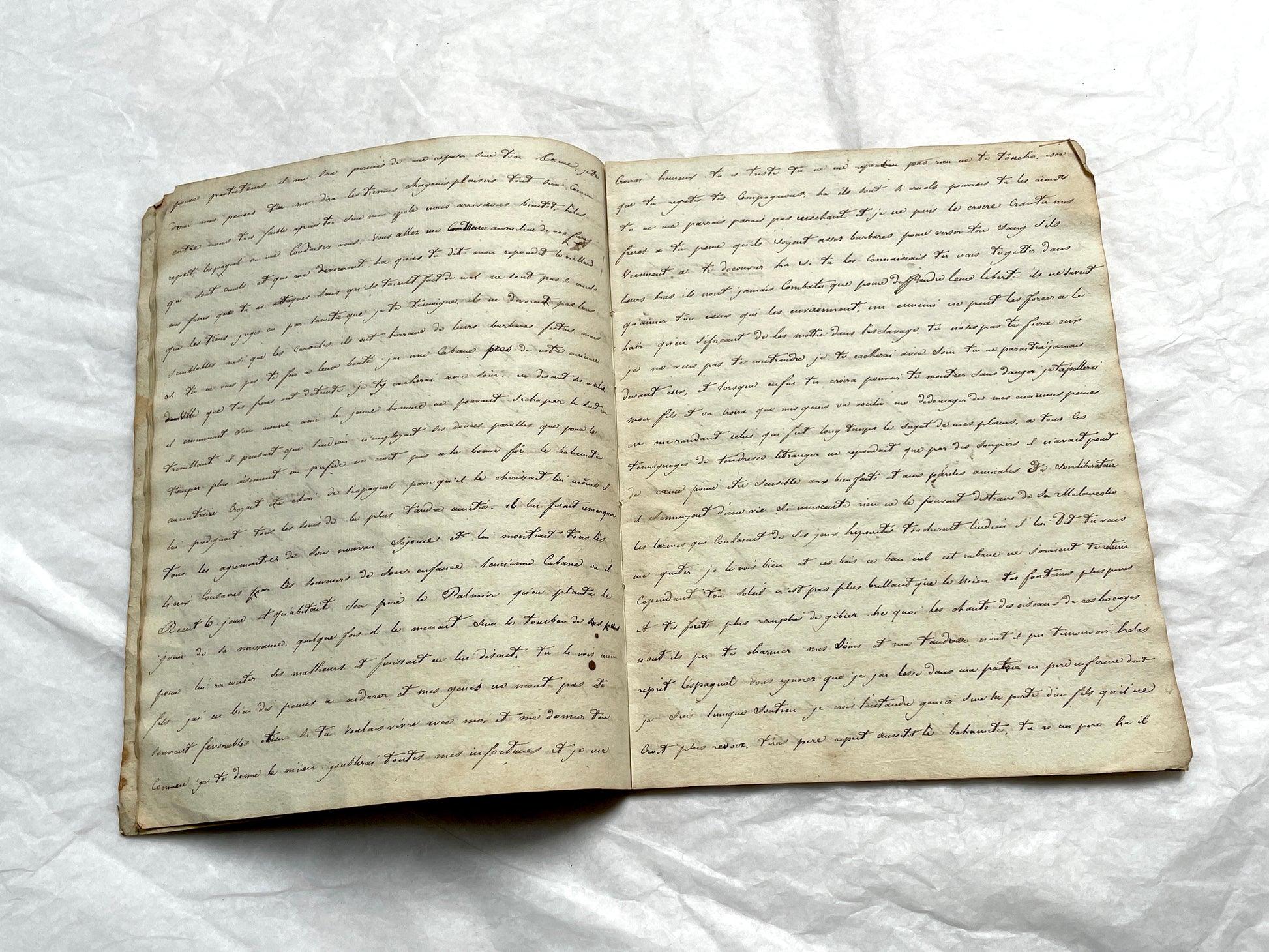 Late 19th Century handwritten French manuscript book with aged pages open to reveal flowing script.