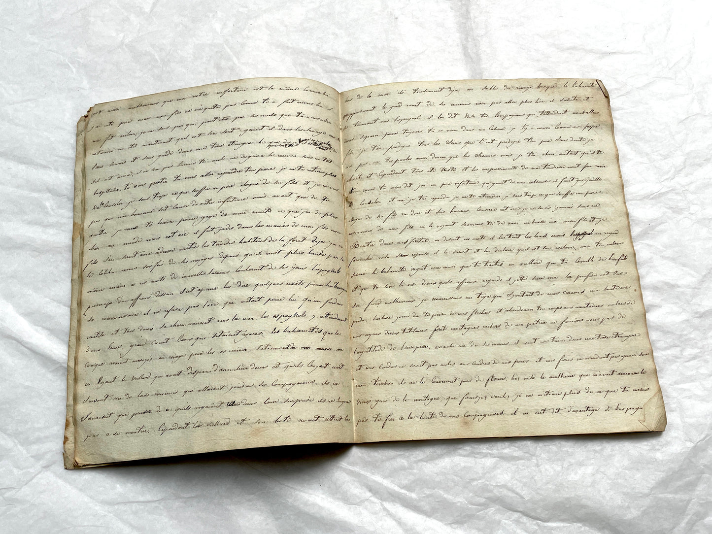 Late 19th Century handwritten French manuscript book with aged pages open to reveal flowing script.