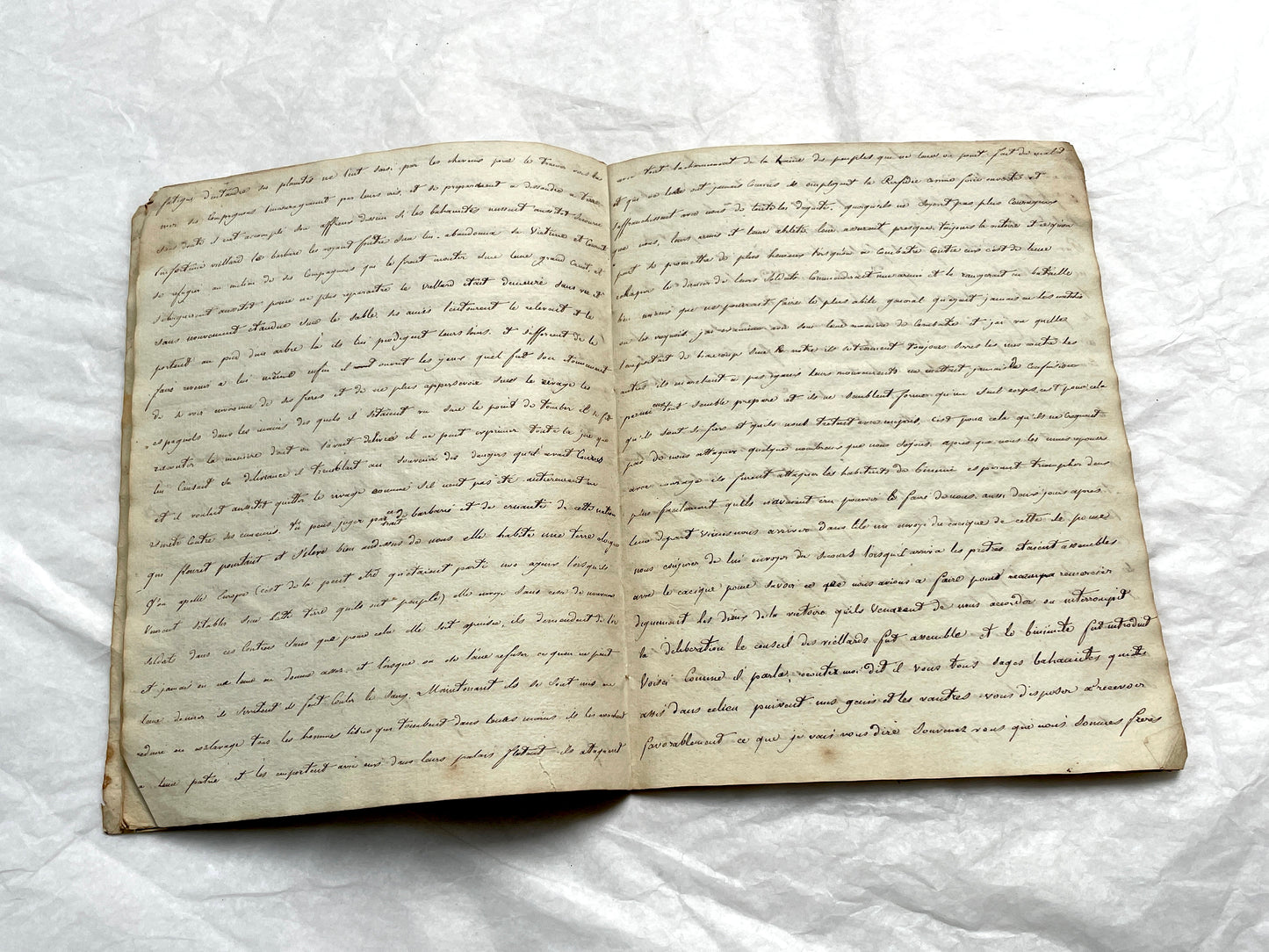 Late 19th Century handwritten French manuscript book with aged pages open to reveal flowing script.
