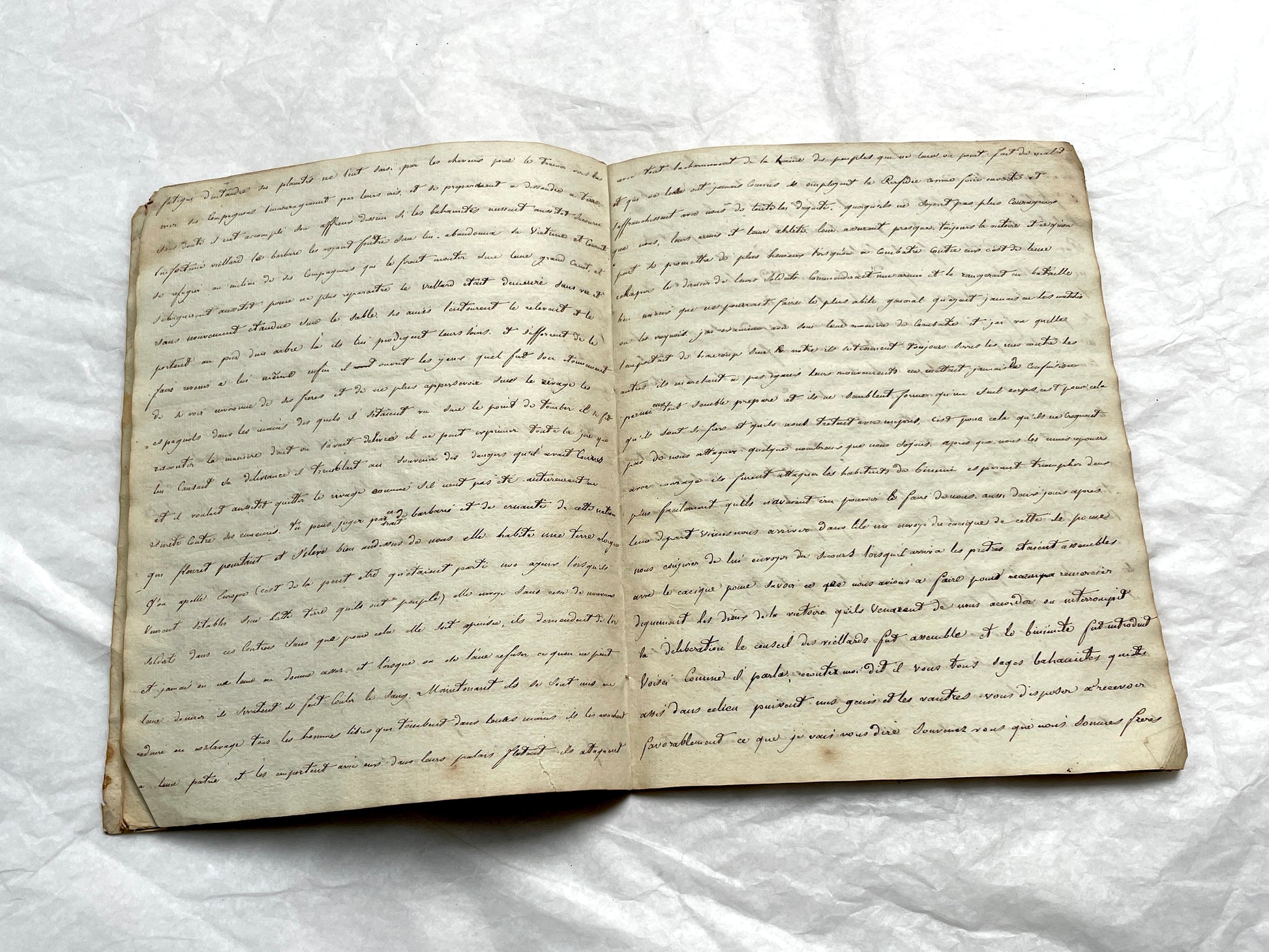Late 19th Century handwritten French manuscript book with aged pages open to reveal flowing script.