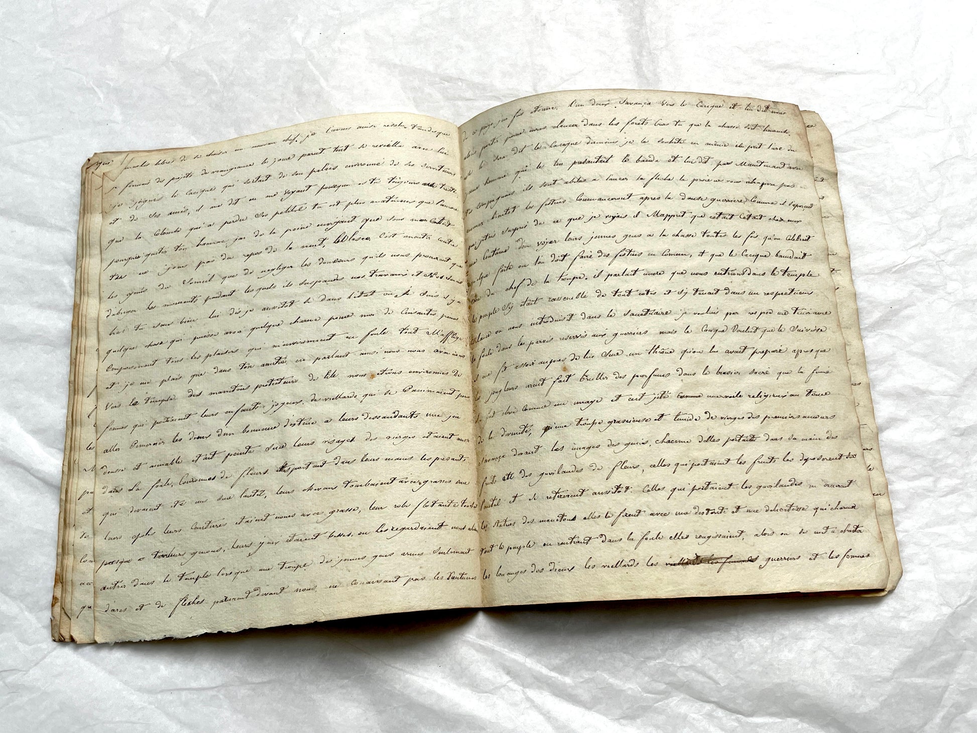 Late 19th Century handwritten French manuscript book with aged pages open to reveal flowing script.