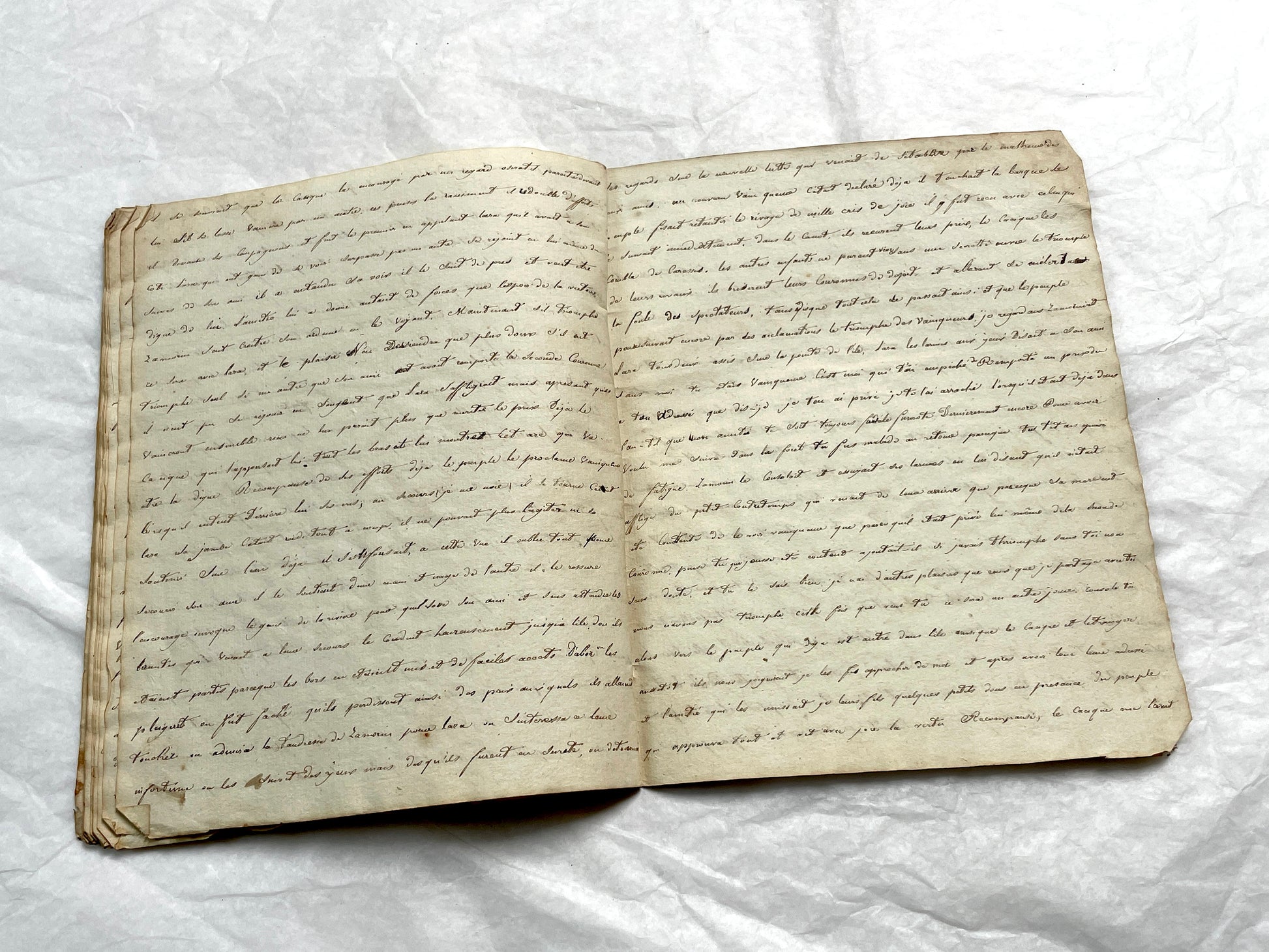 Late 19th Century handwritten French manuscript book with aged pages open to reveal flowing script.