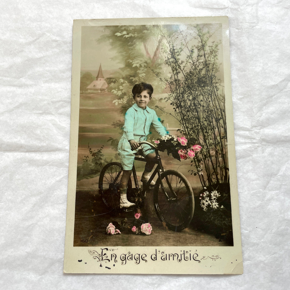 1900s French Postcard Lot featuring charming children on a bicycle, holding flowers, and in an antique car.