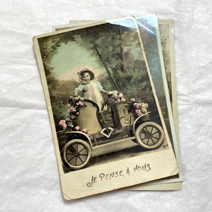1900s French Postcard Lot featuring charming children on a bicycle, holding flowers, and in an antique car.