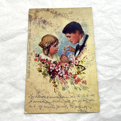 Two 1910s vintage French postcards featuring romantic couples with flowers and New Year greetings.