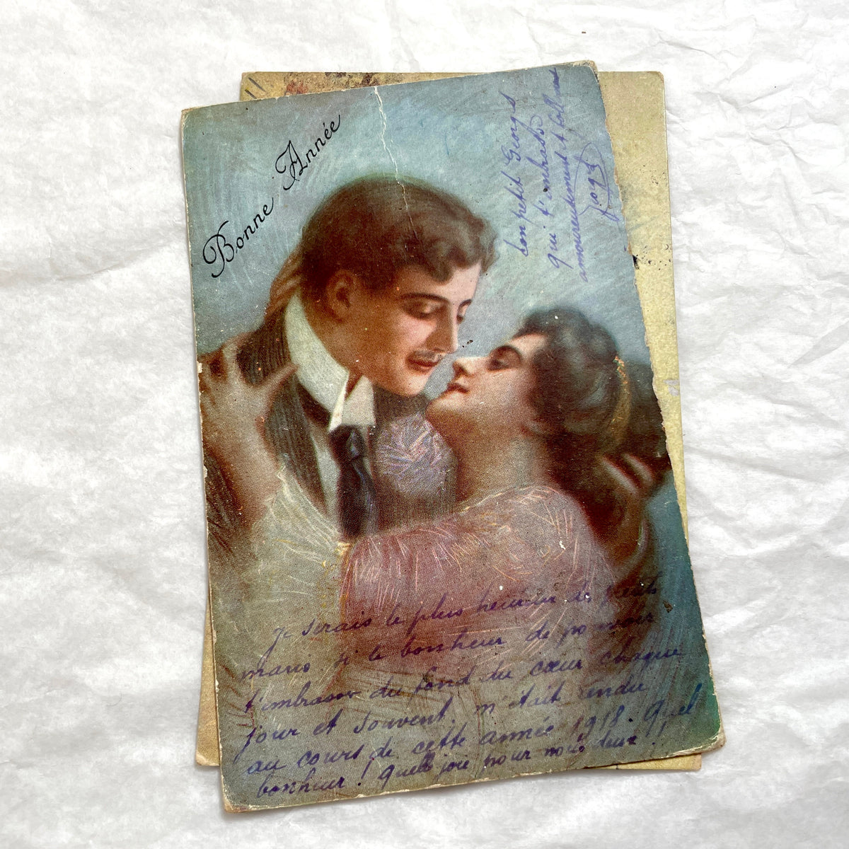 Two 1910s vintage French postcards featuring romantic couples with flowers and New Year greetings.