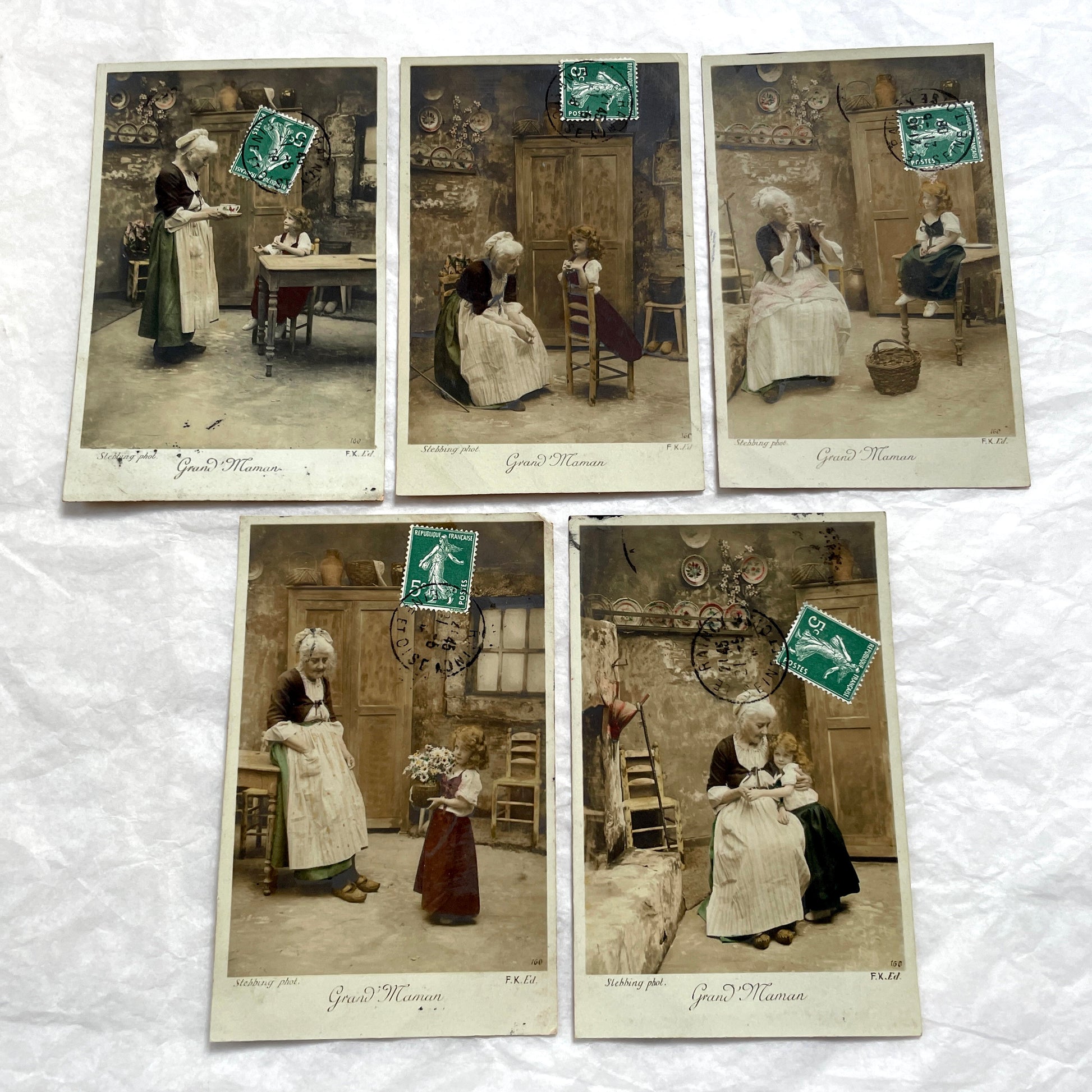 1910s French postcard lot of 5, featuring sepia-toned photos of a grandmother and granddaughter in daily scenes.