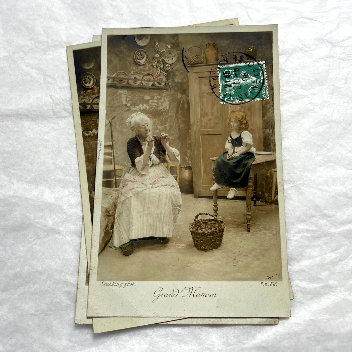 1910s French postcard lot of 5, featuring sepia-toned photos of a grandmother and granddaughter in daily scenes.
