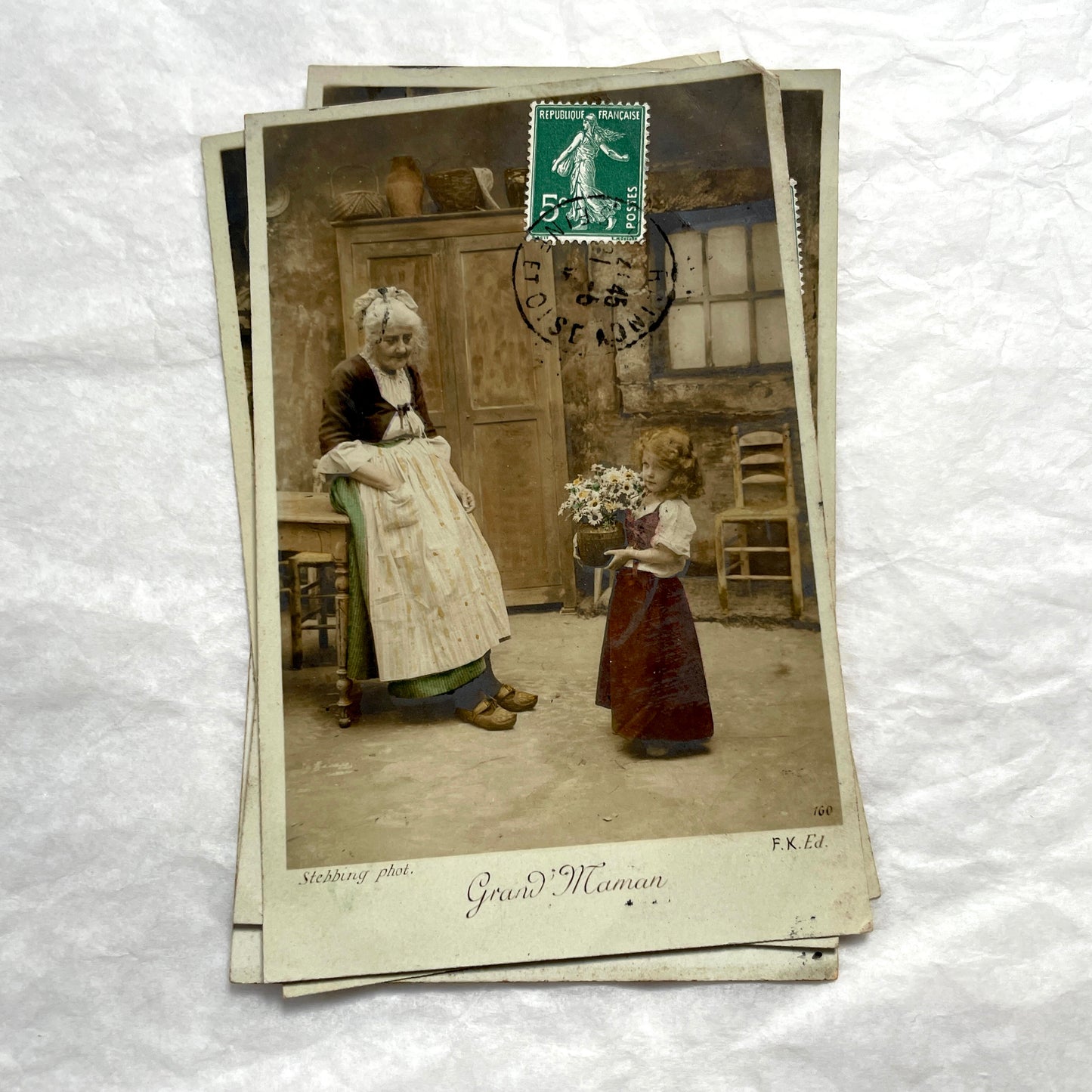 1910s French postcard lot of 5, featuring sepia-toned photos of a grandmother and granddaughter in daily scenes.