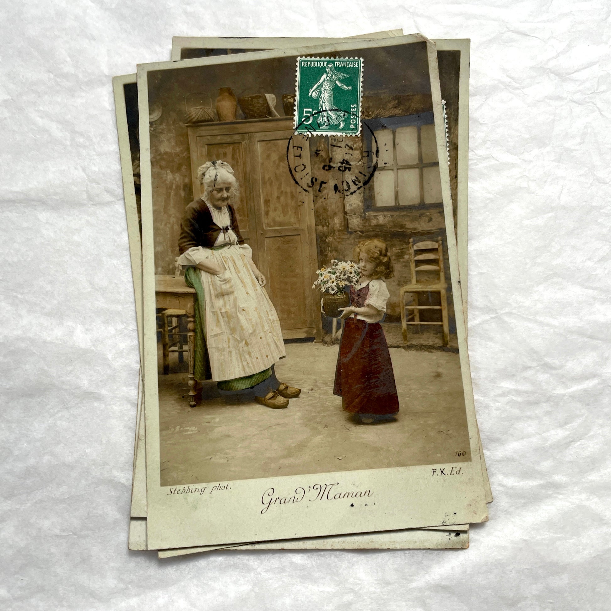 1910s French postcard lot of 5, featuring sepia-toned photos of a grandmother and granddaughter in daily scenes.