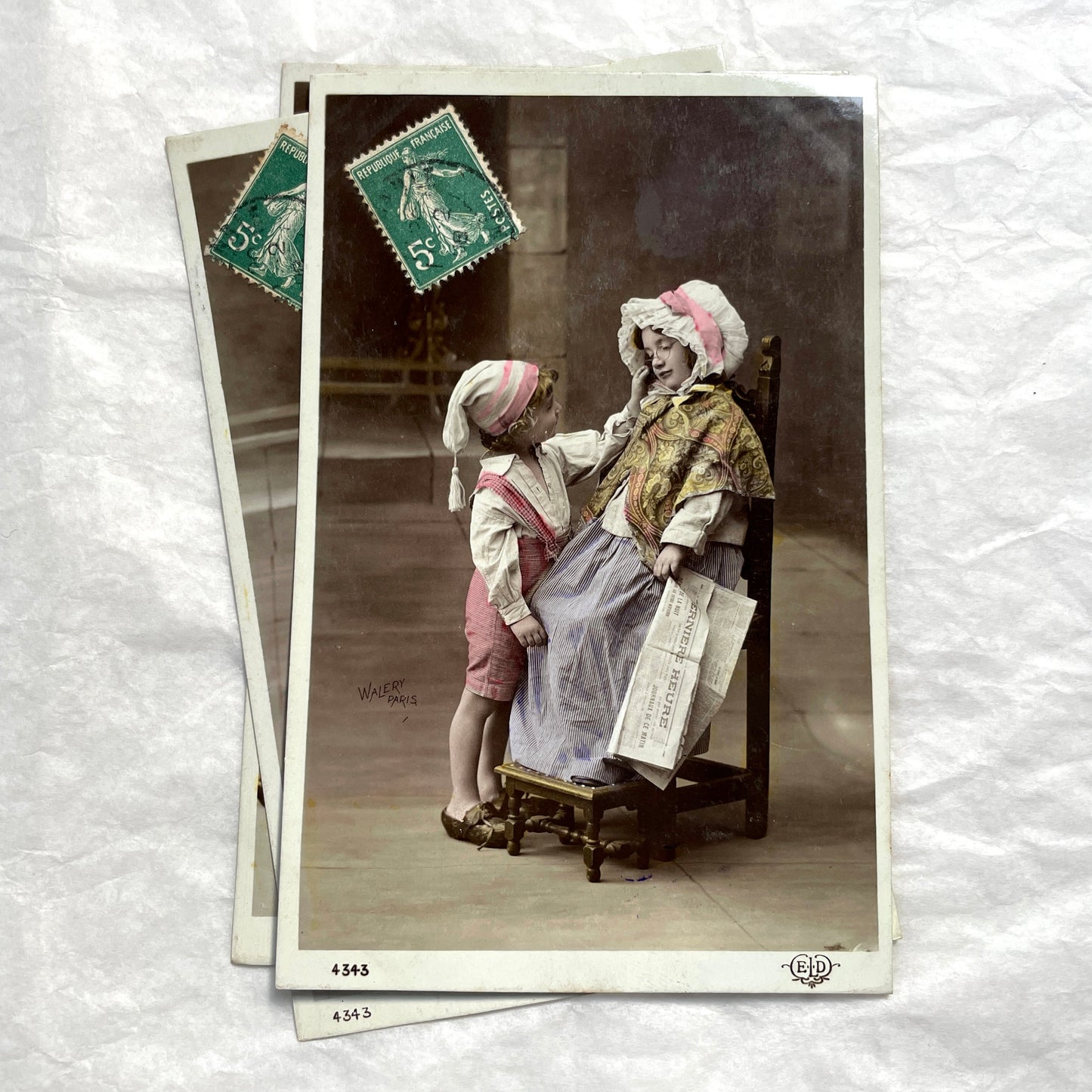 1900s French Postcards Lot - Hand-colored images of children with bonnets and newspaper by Walery Paris.