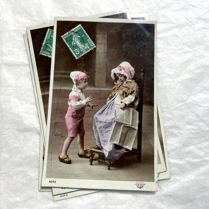 1900s French Postcards Lot - Hand-colored images of children with bonnets and newspaper by Walery Paris.