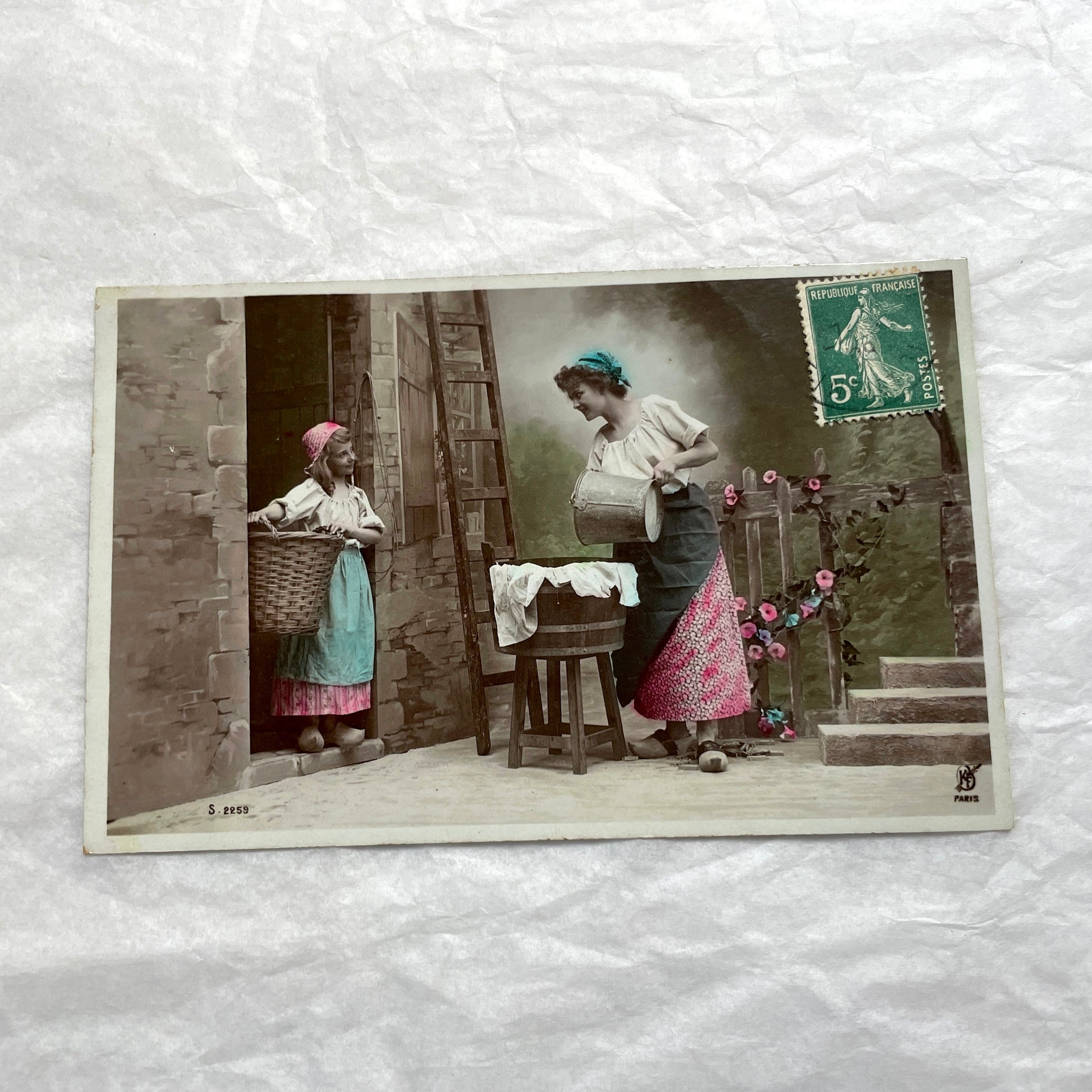 Lot of 6 1910s French postcards depicting women washing laundry in a village setting with visible French stamps.