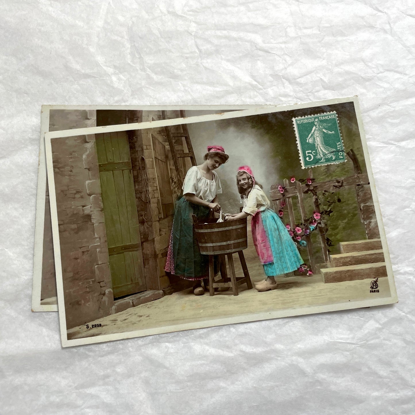 Lot of 6 1910s French postcards depicting women washing laundry in a village setting with visible French stamps.