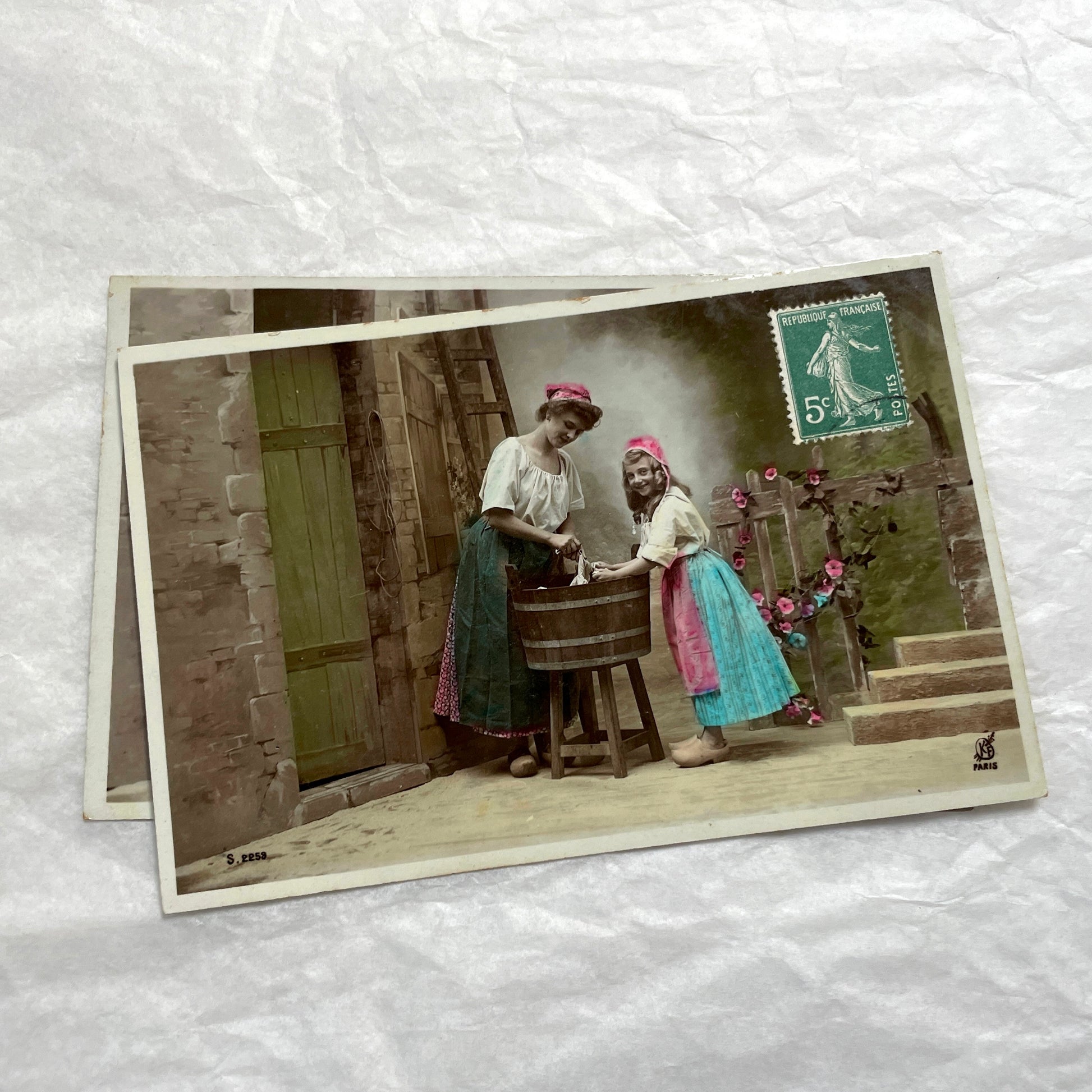 Lot of 6 1910s French postcards depicting women washing laundry in a village setting with visible French stamps.